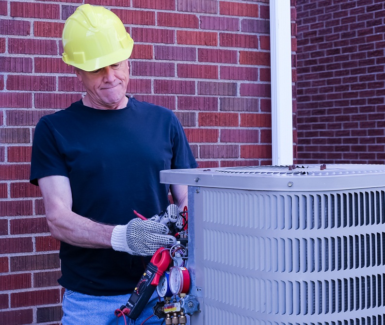 HVAC tech with outdoor HVAC unit