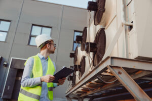 male service technician inspecting a commercial HVAC unit